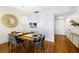 Dining space featuring a wooden table with modern seating, stylish lighting, and an open view to the kitchen at 19029 Us Highway 19 N # 5-14, Clearwater, FL 33764