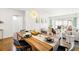 Dining area featuring a wooden table, stylish chairs, modern lighting, and an open view to the living room at 19029 Us Highway 19 N # 5-14, Clearwater, FL 33764
