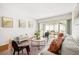 Living area with modern furnishings, hardwood floors, and a view to the screened-in lanai with outdoor seating at 19029 Us Highway 19 N # 5-14, Clearwater, FL 33764