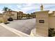 Exterior shot of the condo parking lot showing the 'Algiers' community sign and available parking spots at 19029 Us Highway 19 N # 5-14, Clearwater, FL 33764