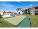 Putting Green view surrounded by condo buildings and tropical palm trees at 19029 Us Highway 19 N # 5-14, Clearwater, FL 33764