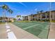 Full Shuffleboard Court surrounded by tropical palm trees and condo buildings at 19029 Us Highway 19 N # 5-14, Clearwater, FL 33764
