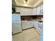 Cozy kitchen featuring white appliances and backsplash detail at 1921 58Th N Ave # 11, St Petersburg, FL 33714