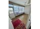 Bright sunroom with natural light streaming through sheer curtains and colorful rug at 1921 58Th N Ave # 11, St Petersburg, FL 33714