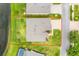 Aerial view of home showing a fenced backyard near a pond and paved drive at 19819 Tattnall Way, Brooksville, FL 34601