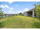 Expansive backyard with lush green grass and lake views at 19819 Tattnall Way, Brooksville, FL 34601