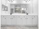 Bright bathroom features double sink vanity with a large mirror and black hardware at 19819 Tattnall Way, Brooksville, FL 34601