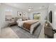 A spacious bedroom with modern decor with two windows that allow for natural light to fill the space at 19819 Tattnall Way, Brooksville, FL 34601