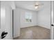 Cozy bedroom showcases tile flooring, a ceiling fan, a built-in wardrobe, and a window at 19819 Tattnall Way, Brooksville, FL 34601