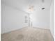 Spacious bedroom featuring neutral carpet, ceiling fan, and an ensuite bathroom at 19819 Tattnall Way, Brooksville, FL 34601