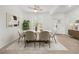 Bright dining area showcasing a modern table set, stylish rug, and ample natural light from large windows at 19819 Tattnall Way, Brooksville, FL 34601