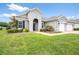 Charming home with a well-manicured lawn and attached garage at 19819 Tattnall Way, Brooksville, FL 34601