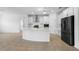 Modern kitchen featuring white cabinetry, stainless steel appliances, and a spacious center island perfect for entertaining at 19819 Tattnall Way, Brooksville, FL 34601
