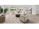 Inviting living room with ample seating, overlooking the lake, adjacent to the stylish kitchen at 19819 Tattnall Way, Brooksville, FL 34601