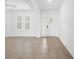 Bright living room features tile flooring, white walls, and a door and large windows for natural light at 19819 Tattnall Way, Brooksville, FL 34601