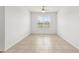 Bright, empty living space with tile flooring, white walls, and a single window creating a calm and serene atmosphere at 19819 Tattnall Way, Brooksville, FL 34601
