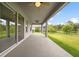 Covered patio with ceiling fans and sliding glass doors at 19819 Tattnall Way, Brooksville, FL 34601