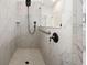 Detailed shot of marble tiled shower featuring black showerhead and matching hardware at 19819 Tattnall Way, Brooksville, FL 34601