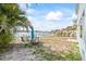 Waterfront backyard with a patio dining set, lush tropical foliage and gorgeous views at 2010 20Th Avenue Pkwy, Indian Rocks Beach, FL 33785