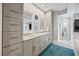 Bright bathroom featuring double vanities, ample storage, and a rug at 2010 20Th Avenue Pkwy, Indian Rocks Beach, FL 33785