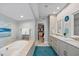 Spacious bathroom with a soaking tub, double vanity, and access to a walk-in closet at 2010 20Th Avenue Pkwy, Indian Rocks Beach, FL 33785