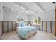 Bedroom with white ceiling beams, tile floor, and a bed with blue and white bedding at 2010 20Th Avenue Pkwy, Indian Rocks Beach, FL 33785