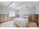 Bedroom with white ceiling beams, tile floor, and a bed with white bedding at 2010 20Th Avenue Pkwy, Indian Rocks Beach, FL 33785
