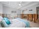 Bedroom with white ceiling beams, tile floor, and a bed with blue and white bedding at 2010 20Th Avenue Pkwy, Indian Rocks Beach, FL 33785