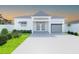 Modern-style home with sleek lines, a well-manicured lawn, and minimalist landscaping at 2010 20Th Avenue Pkwy, Indian Rocks Beach, FL 33785