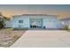Charming, light blue, single-story home with a well-kept lawn and a welcoming front entrance at 2010 20Th Avenue Pkwy, Indian Rocks Beach, FL 33785
