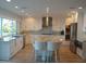 Modern kitchen featuring white cabinetry, stainless steel appliances, and a large island with seating at 2010 20Th Avenue Pkwy, Indian Rocks Beach, FL 33785
