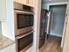 Kitchen with stainless steel double ovens and stainless steel refrigerator at 2010 20Th Avenue Pkwy, Indian Rocks Beach, FL 33785