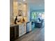 Cozy living area featuring a built-in wet bar, ample cabinet space, and elegant lighting fixtures at 2010 20Th Avenue Pkwy, Indian Rocks Beach, FL 33785
