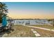 Stunning riverfront view reflecting an orange-hued sky with a picturesque community in the distance at 2010 20Th Avenue Pkwy, Indian Rocks Beach, FL 33785
