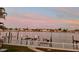 Calm water view from backyard, showing a glimpse of neighborhood homes and sunset at 2010 20Th Avenue Pkwy, Indian Rocks Beach, FL 33785