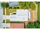 Aerial view showcases this home's light grey roof, tidy landscaping, and concrete driveway at 22943 Sills Loop, Land O Lakes, FL 34639