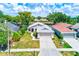 Aerial view of the home showcases the attached two-car garage and landscaped lawn at 22943 Sills Loop, Land O Lakes, FL 34639