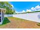 A view of the spacious backyard with lush lawn and white vinyl fencing at 22943 Sills Loop, Land O Lakes, FL 34639