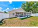 A view of the house from the fenced backyard shows the screened-in lanai at 22943 Sills Loop, Land O Lakes, FL 34639