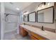 Bathroom with double sink vanity and shower with accessibility bar offers a stylish and practical space at 22943 Sills Loop, Land O Lakes, FL 34639