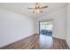 Bright bedroom with a sliding glass door to a private patio and ceiling fan offers outdoor access at 22943 Sills Loop, Land O Lakes, FL 34639