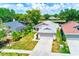 Aerial view of home featuring a well-maintained lawn, pristine driveway, and lush landscaping at 22943 Sills Loop, Land O Lakes, FL 34639