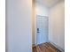 Bright hallway with wood floors leading to various rooms within the home at 22943 Sills Loop, Land O Lakes, FL 34639