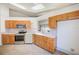 Functional kitchen with stainless steel appliances, light wood cabinets, and ample counter space at 22943 Sills Loop, Land O Lakes, FL 34639