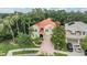 Beautiful home with a red tile roof, lush landscaping, and a spacious driveway at 2354 Messenger Cir, Safety Harbor, FL 34695