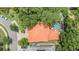 A captivating aerial view of a beautiful home with a terracotta roof and a refreshing pool and mature landscaping at 2354 Messenger Cir, Safety Harbor, FL 34695