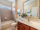 Neutral bathroom featuring a framed mirror over the vanity, shower, tub, and toilet combo at 2354 Messenger Cir, Safety Harbor, FL 34695