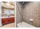 Elegant bathroom featuring neutral tile shower and floors, with a peek at the double vanity at 2354 Messenger Cir, Safety Harbor, FL 34695