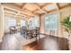 Dining room featuring a decorative ceiling, chandelier, hardwood floors, and a table set for eight at 2354 Messenger Cir, Safety Harbor, FL 34695