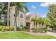 Stunning two-story home featuring lush landscaping, palm trees, and a well-manicured lawn at 2354 Messenger Cir, Safety Harbor, FL 34695